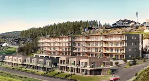 Illustrasjonsfoto av leilighetsbygg i en skråning, men små eneboliger/leiligheter foran.